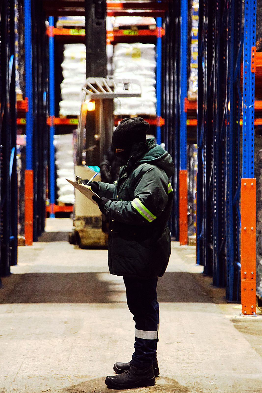 Operator taking inventory inside the frozen storage chamber — Tonari Peru